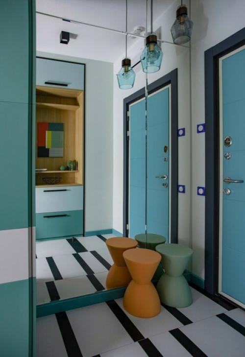 Яркая студия, в которой уместили кухню, гостиную и спальню. 05