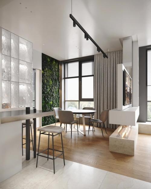 Воздушная кухня - гостиная, в которой пространство разделено с помощью стойки тв.