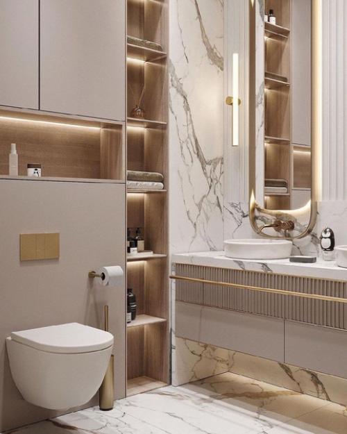 Стильный санузел.  Золото на фоне белого мрамора выделяется.